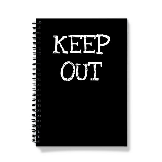 A spiralbound notebook with a black cover and the words "keep out" written in large white text.