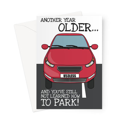 Funny birthday card featuring a red car parked badly across a white line, with a humorous message about aging and not learning how to park. The car's license plate reads "U53LESS," adding to the joke. The design has a playful, cartoon-style illustration on a dark background.