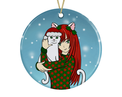 A round ceramic Christmas decoration to hang from a tree. Has a hand drawn illustration of a girl with long red hair in an anime style, cuddling her pet pussy cat.