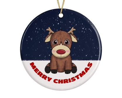 A round ceramic Christmas decoration to hang from a tree. Has a hand drawn illustration of a cute red nosed reindeer sitting in the snow.