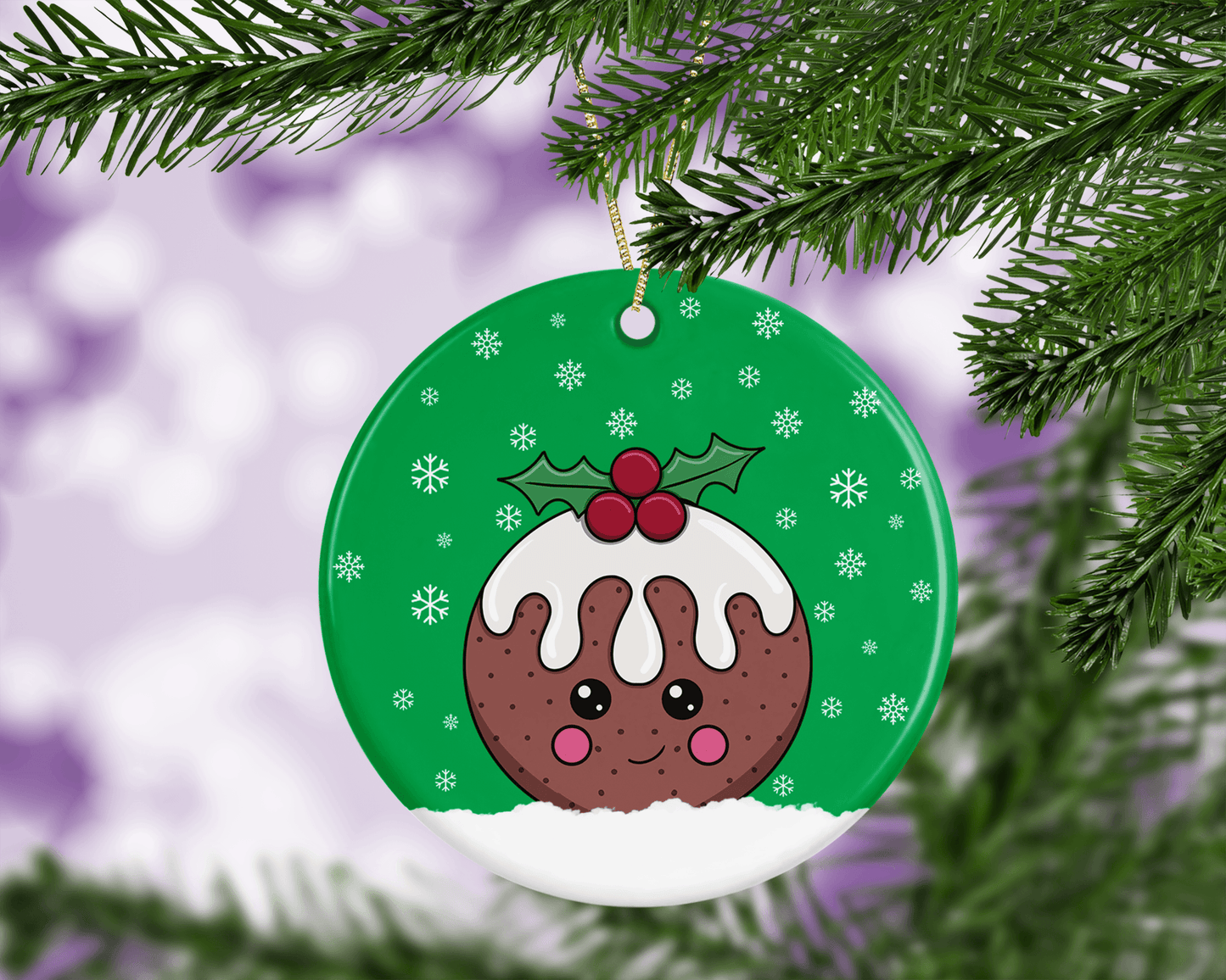 A round ceramic Christmas decoration to hang from a tree. Has a hand drawn illustration of a cute figgy pudding with a green snowy background.