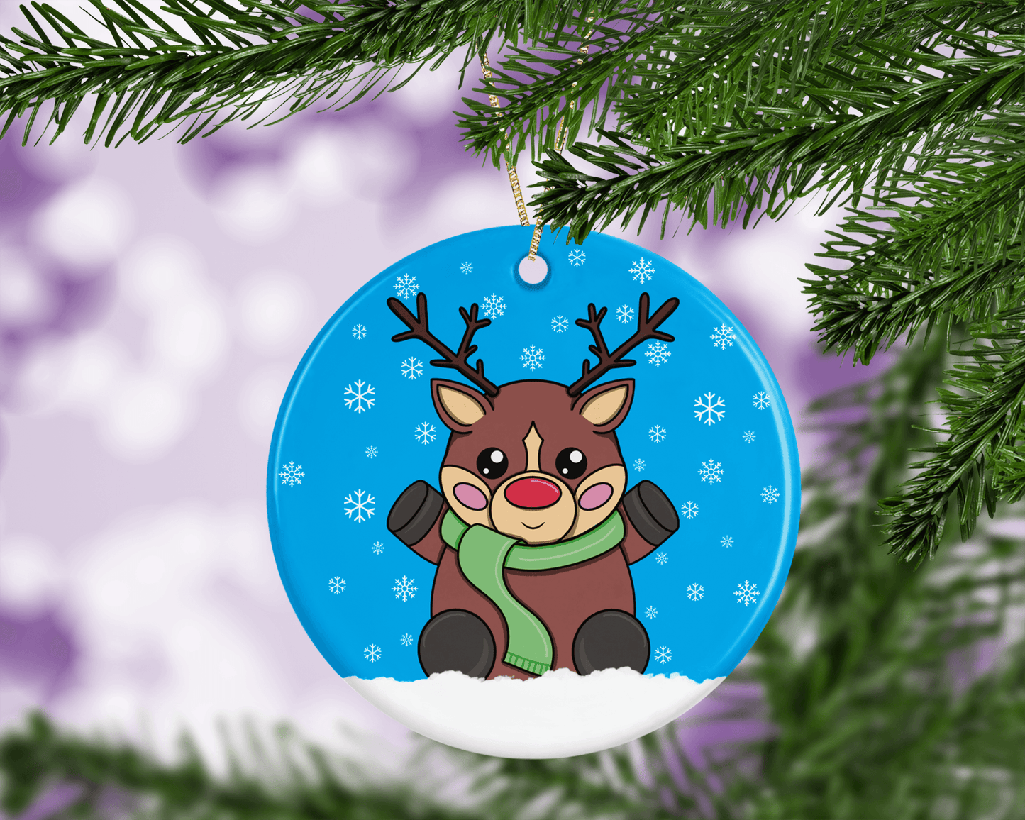 A round ceramic Christmas decoration to hang from a tree. Has a hand drawn illustration of a cute red nosed reindeer with a blue snowy background.