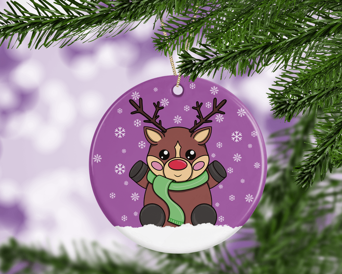 A round ceramic Christmas decoration to hang from a tree. Has a hand drawn illustration of a cute red nosed reindeer with a purple snowy background.